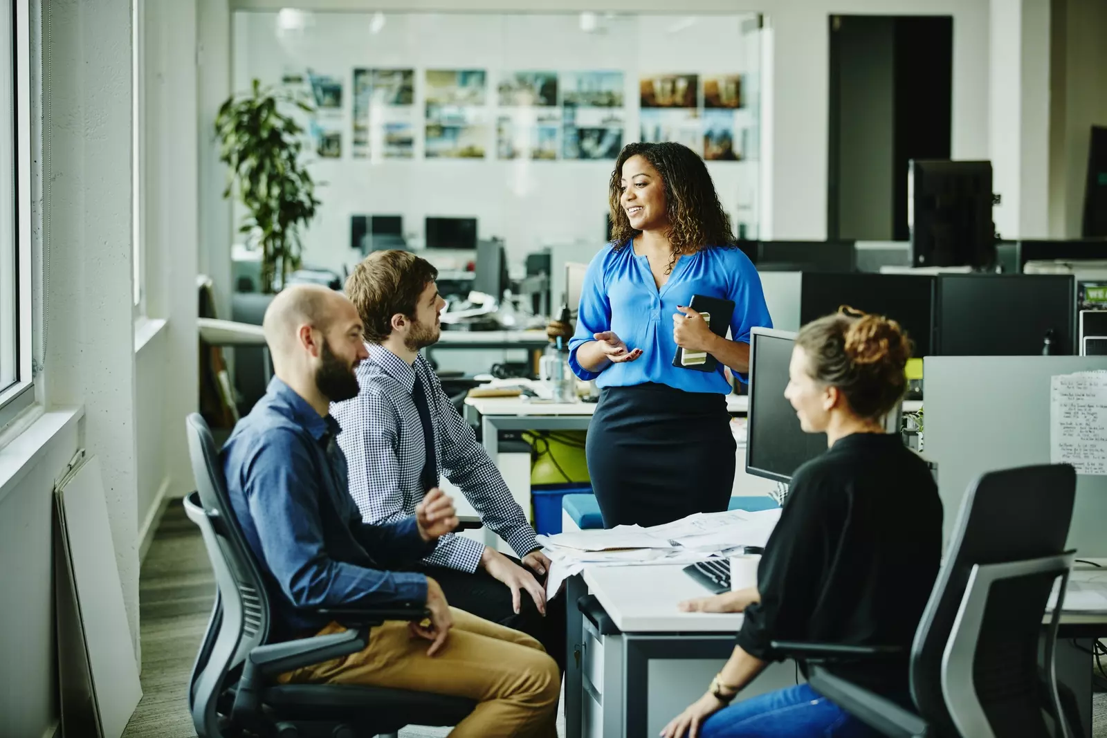 Blue shirt woman with coworkers