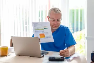 Male Nurse Reviewing Budgets