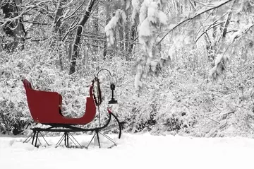 A red sleigh against a snowy backdrop