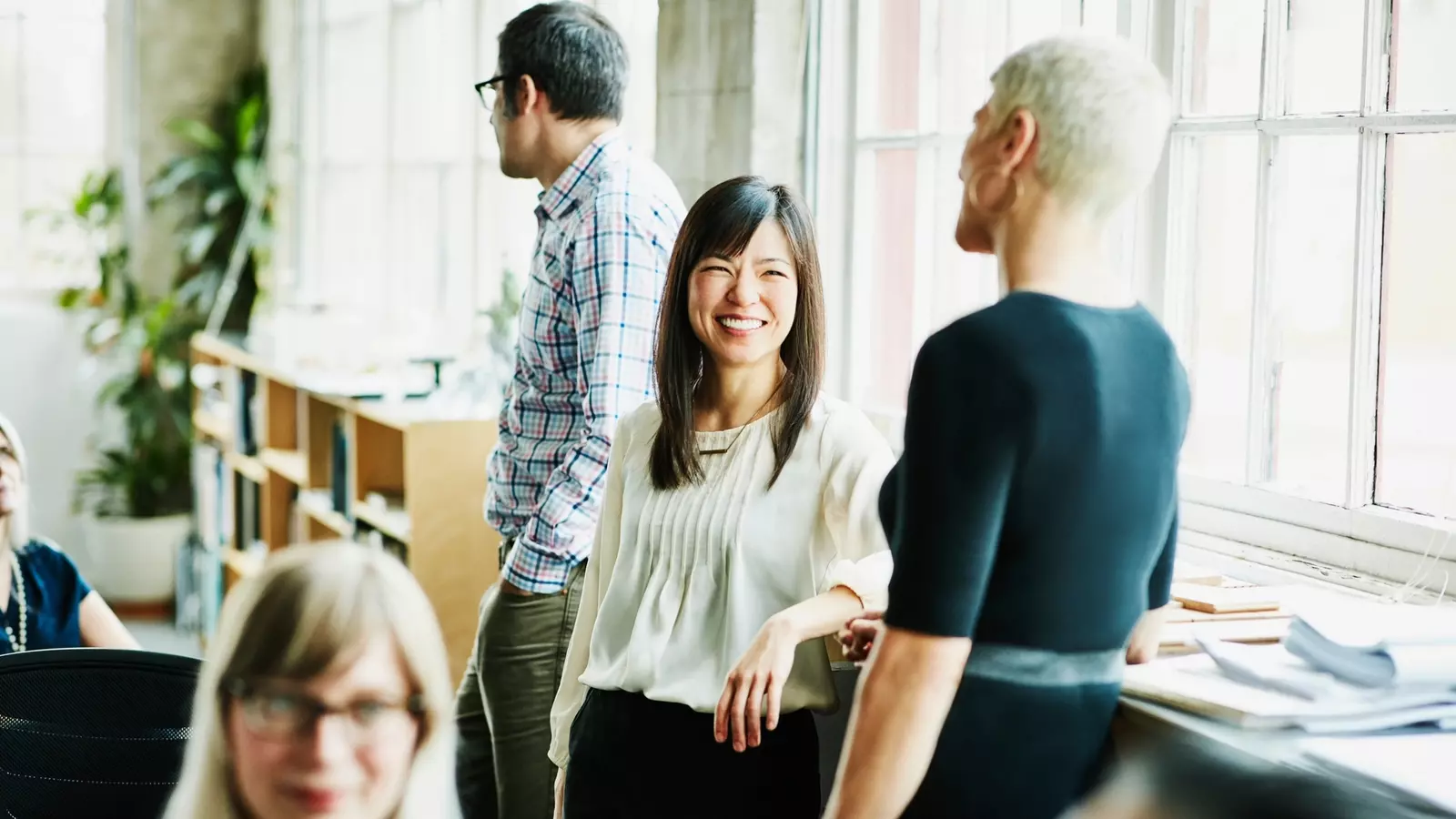 Smiling coworkers in discussion in office