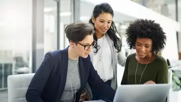 Three women discussing salary and pay transparency