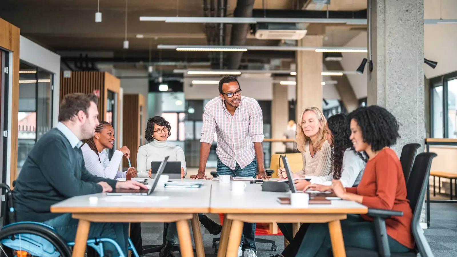 team of colleagues work together around a table